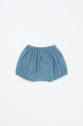 Avauma Linen Bloomer Sky product shot. Light blue baby bloomers with elastic waist and two wooden buttons on a white background.